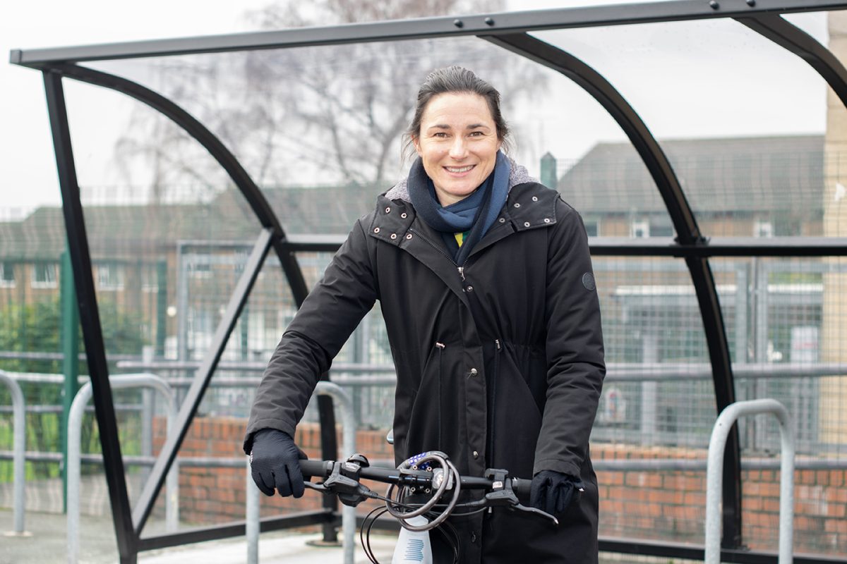 Active Travel Commissioner Dame Sarah Storey standing with her bicycle